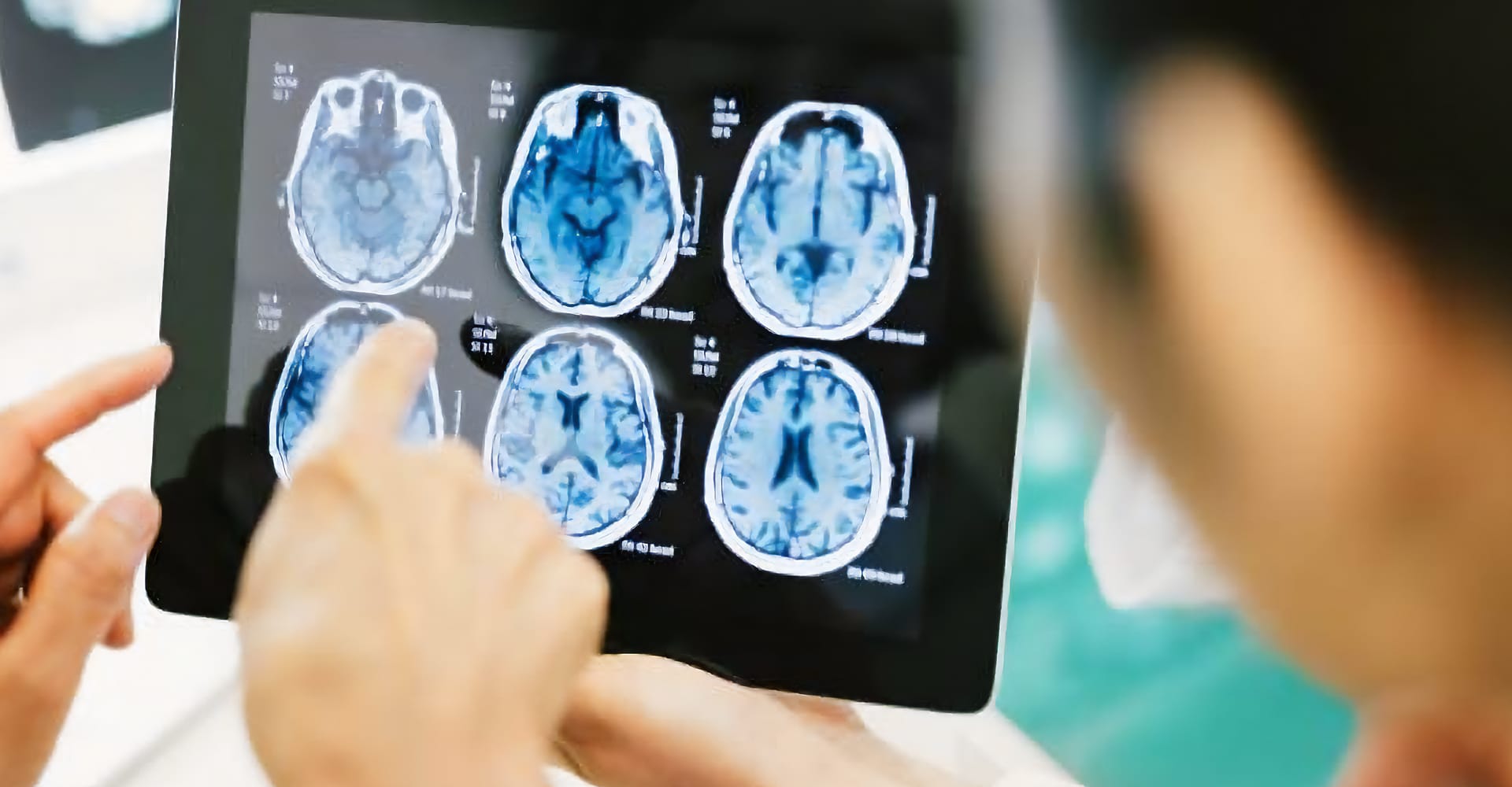 A health care provider examining scans of a patient