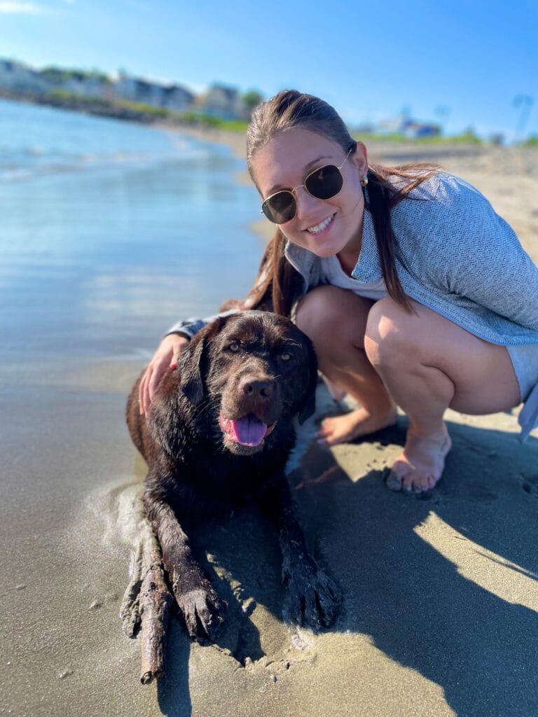 Kailene Jones, FNP with her dog Odin on a beach