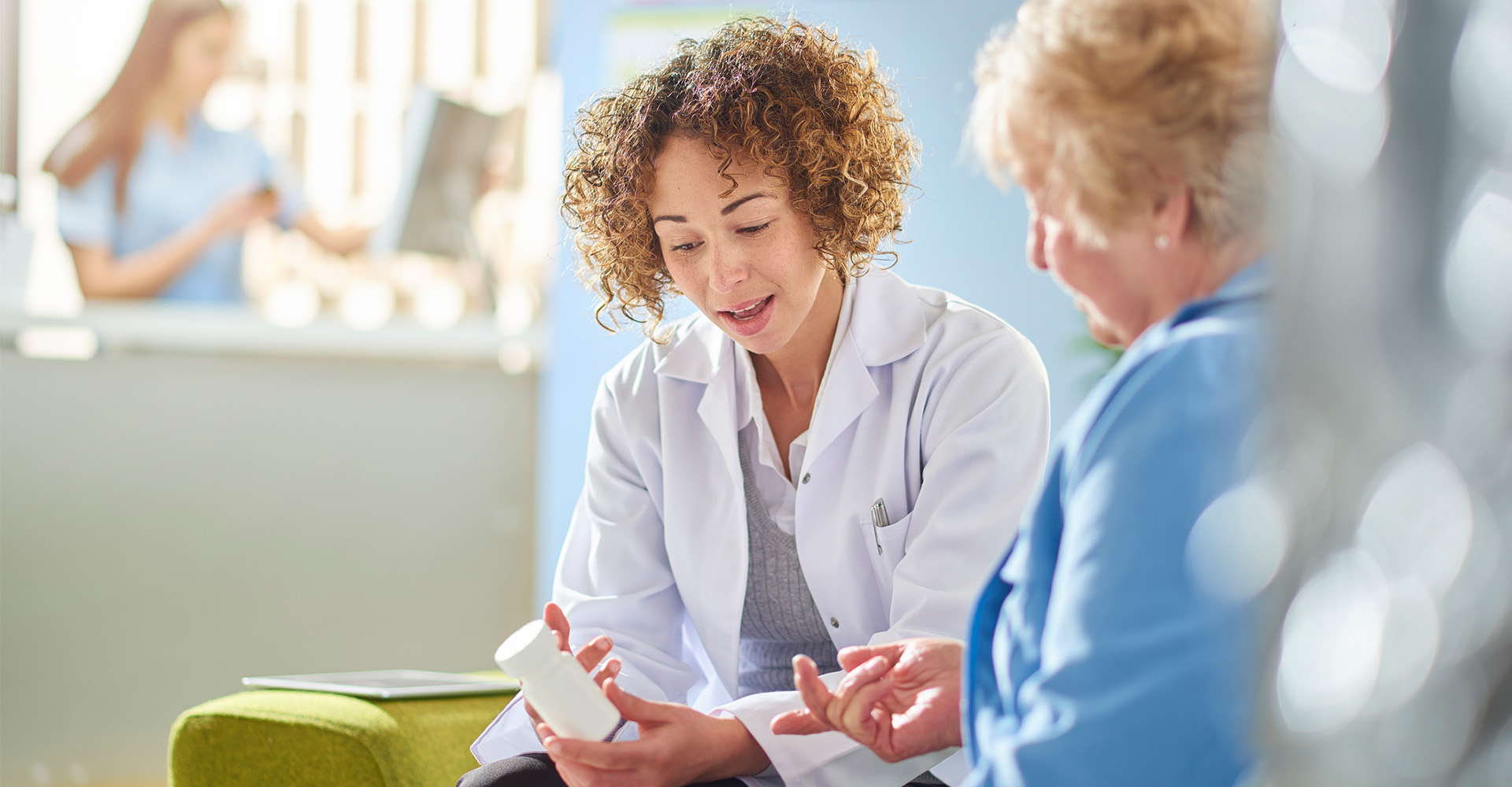 clinical pharmacist reviewing medications with a patient